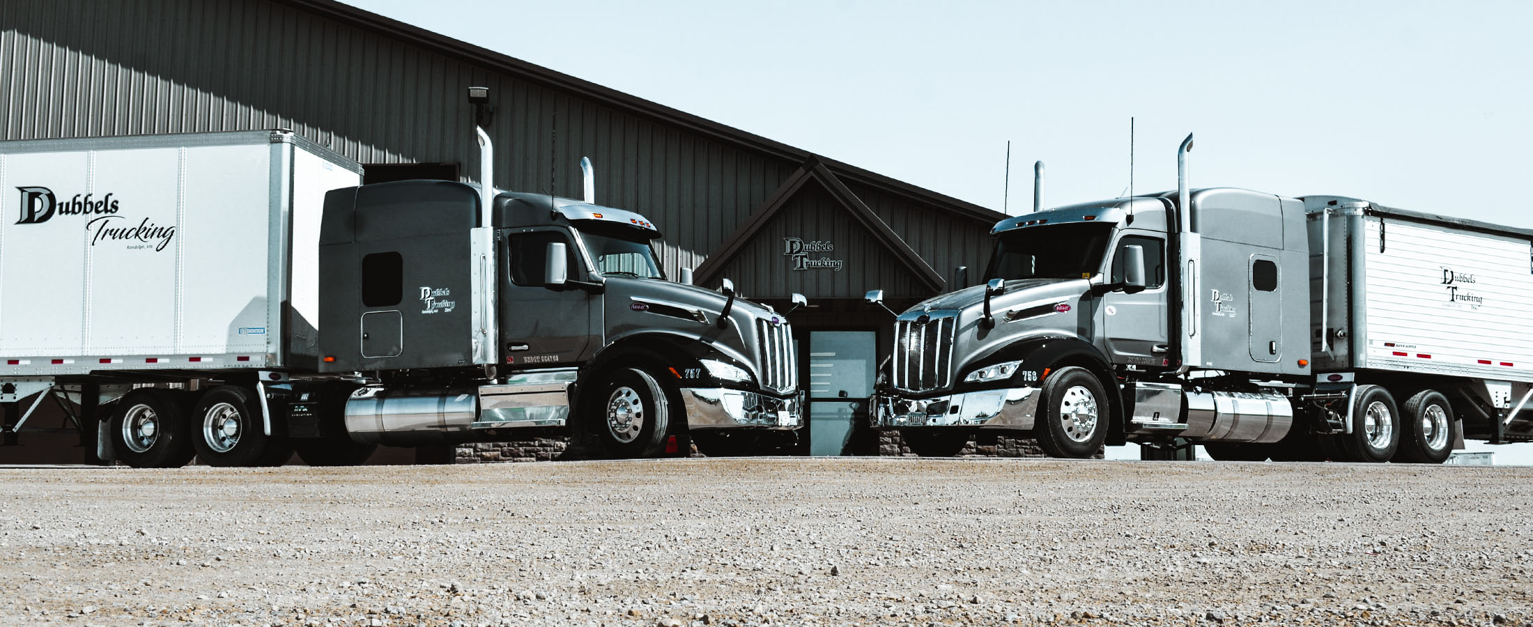 Two Dubbels Trucking semi tractors in front of Dubbels Trucking building | Fleet Services
